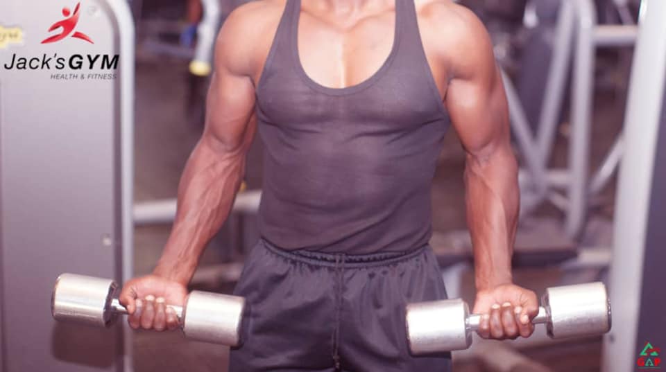 Fit member showcasing muscular physique and confidence after fitness transformation